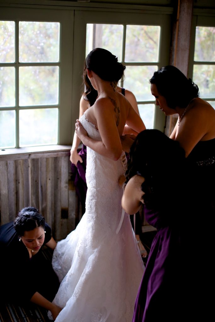 Rustic fall wedding at Calamigos Ranch, bride getting ready in wedding dress