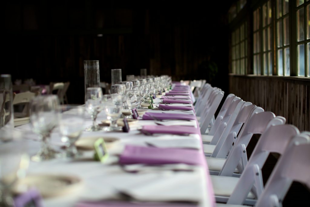 Rustic fall wedding at Calamigos Ranch, reception table with purple napkins
