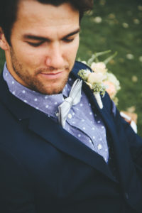 Rustic elegant styled wedding shoot, groom wearing dark navy suit with bowtie and rose boutonnierre