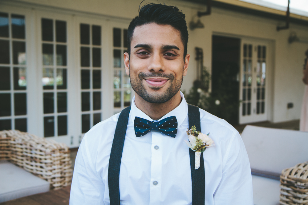Rustic elegant styled wedding shoot, groomsmen with suspenders, bowtie and rose boutonniere