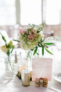 Rustic and elegant wedding at Calamigos Ranch in the Redwood room, reception with watercolored table numbers and blush floral centerpiece
