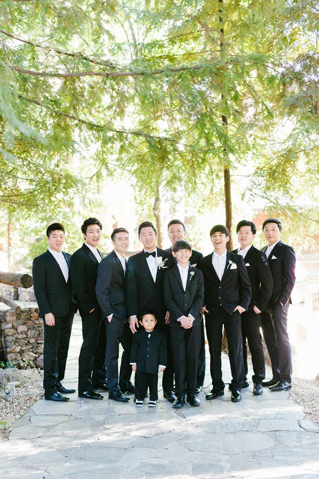 Rustic and elegant wedding at Calamigos Ranch in the Redwood room, groom and groomsmen wearing black tuxedos