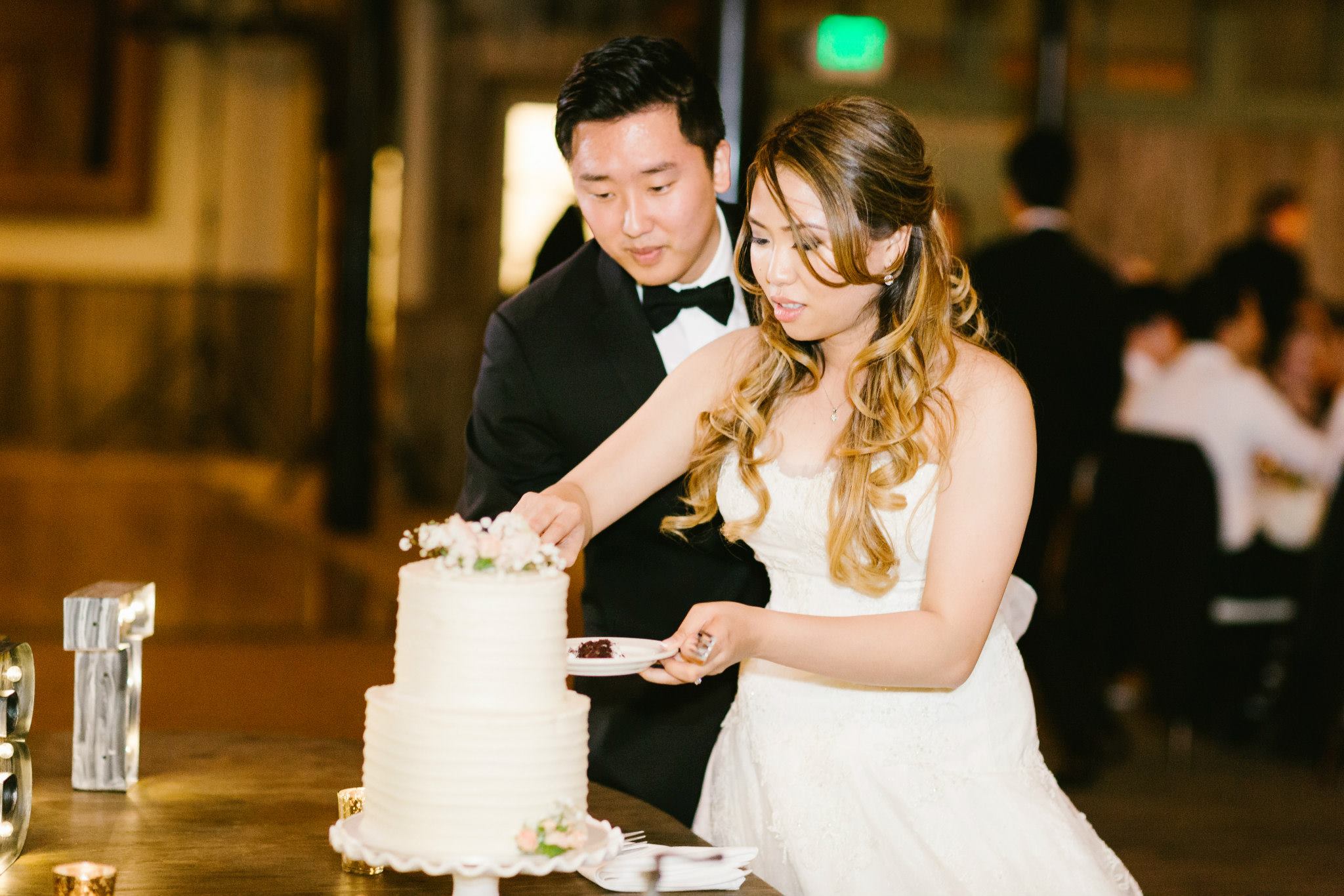 Rustic and elegant wedding at Calamigos Ranch in the Redwood room, bride and groom cutting cake