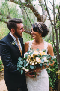 A garden wedding at Mermaid Mountain Inn, bride and groom with eucalyptus bouquet