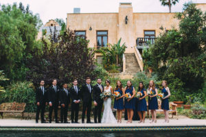 A garden wedding at Mermaid Mountain Inn, wedding party with blue bridesmaid dresses