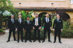 A garden wedding at Mermaid Mountain Inn, groom and groomsmen in black suits