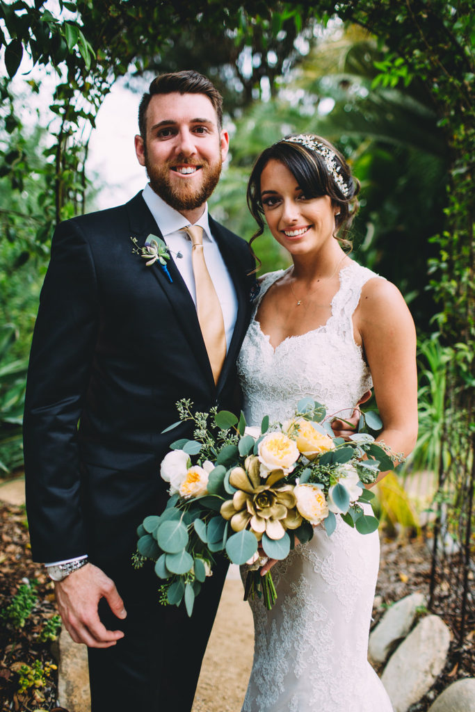 A garden wedding at Mermaid Mountain Inn, bride and groom with eucalyptus bouquet