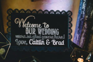 A garden wedding at Mermaid Mountain Inn, wedding welcome sign