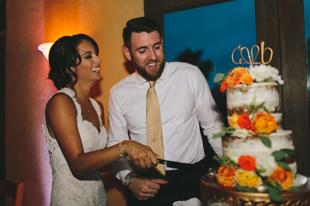 A garden wedding at Mermaid Mountain Inn, bride and groom cutting cake