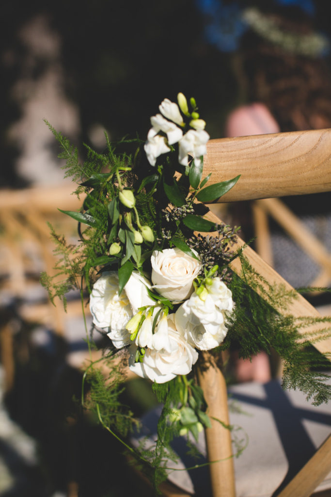 An intimate wedding at Triunfo Creek Vineyards, white rose florals for the aisle