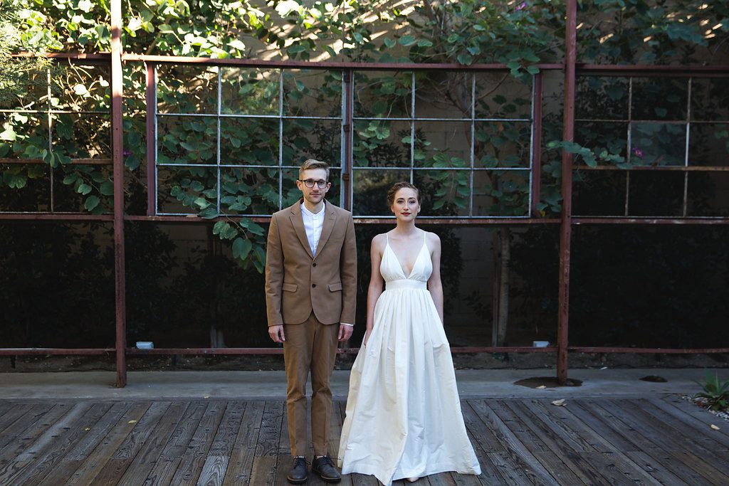 Unique wedding at Elysian LA, groom in brown suit and glasses, bride with simple white dress
