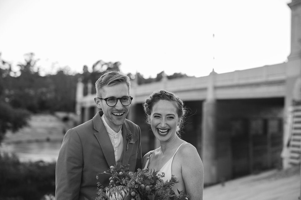 Unique wedding at Elysian LA, bride and groom portrait with groom in brown suit and glasses, bride with simple white dress and red lipstick