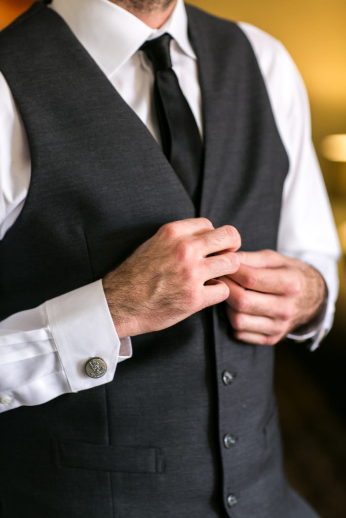 Classic and vintage wedding at Calamigos Ranch, groom getting ready with grey suit