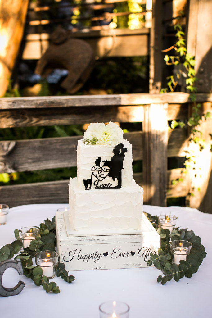 Classic and vintage wedding at Calamigos Ranch, wedding cake with white roses, silhouette cake topper