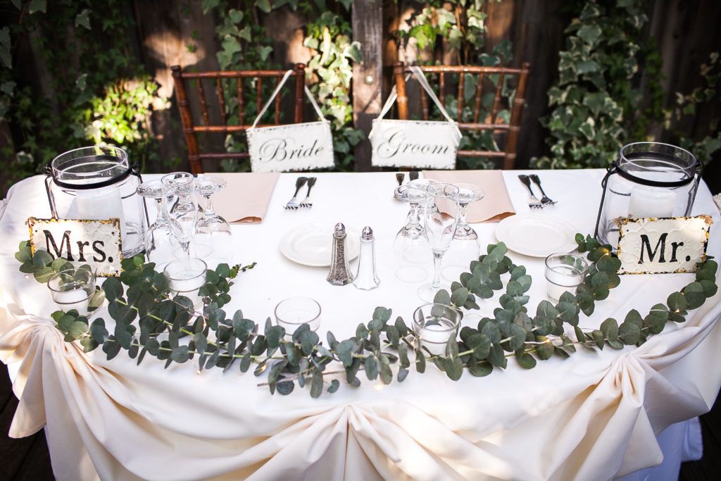 Classic and vintage wedding at Calamigos Ranch, sweetheart table, vintage and rustic bride and groom chair signs