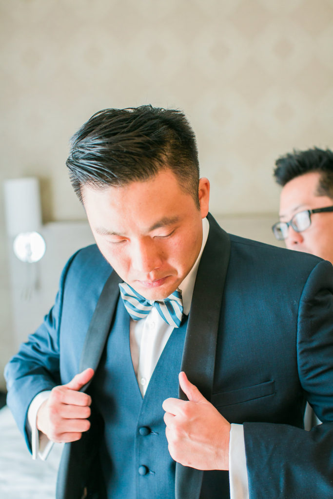 Modern and Chic wedding at Garland Hotel, groom getting ready with striped bowtie