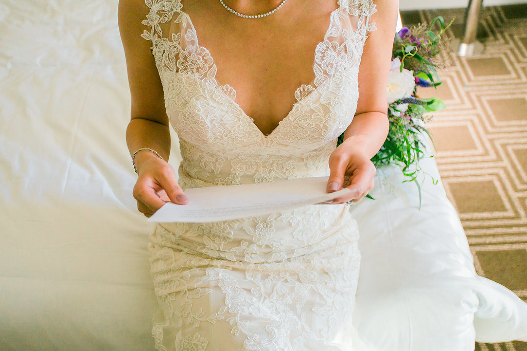 Modern and Chic wedding at Garland Hotel, bride reading note from groom