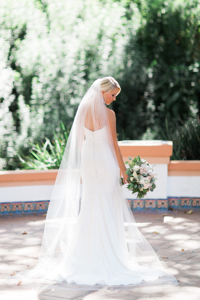 Rancho Las Lomas wedding, bride wearing strapless gown, long chapel veil and white bridal bouquet