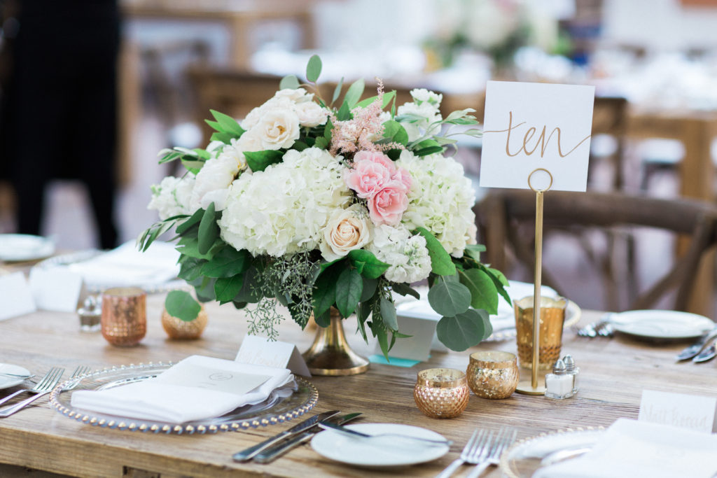 Rancho Las Lomas wedding reception, pink and white flower centerpieces, gold table numbers