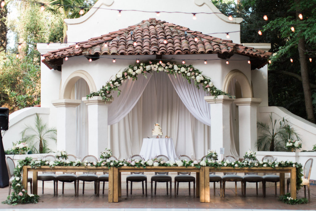 Rancho Las Lomas wedding reception space flip, pink and white flower centerpieces, farm tables