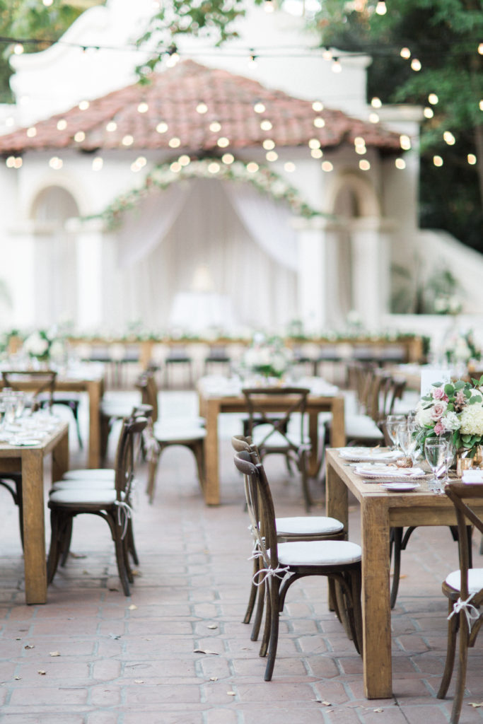Rancho Las Lomas wedding reception, pink and white flower centerpieces, farm tables