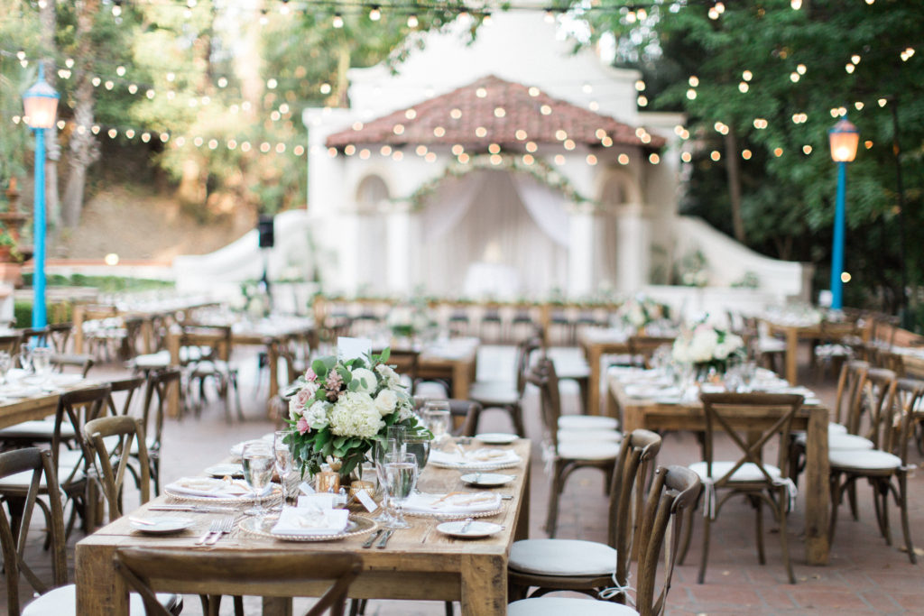 Rancho Las Lomas wedding reception, pink and white flower centerpieces, farm tables