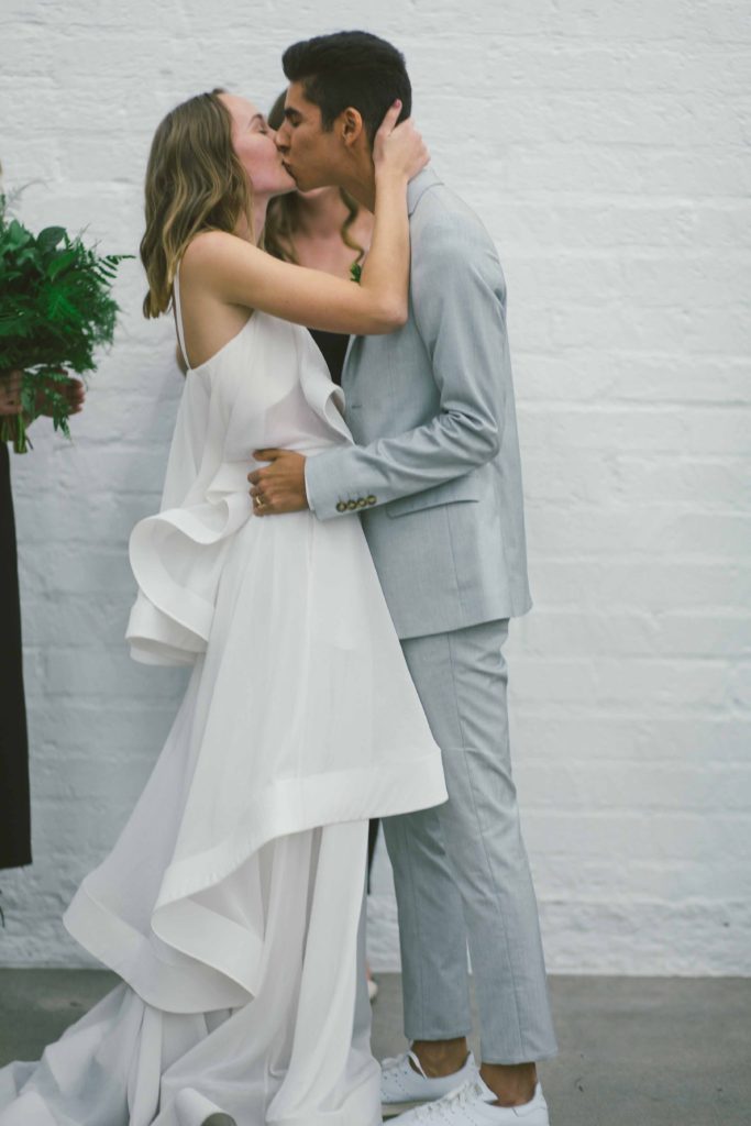 Pantone Color of 2017 inspired minimalist wedding at Hubble Studio in downtown Los Angeles ceremony, modern bride and groom first kiss