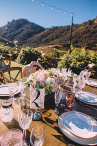 Saddlerock Ranch wedding reception with flower centerpieces and table numbers