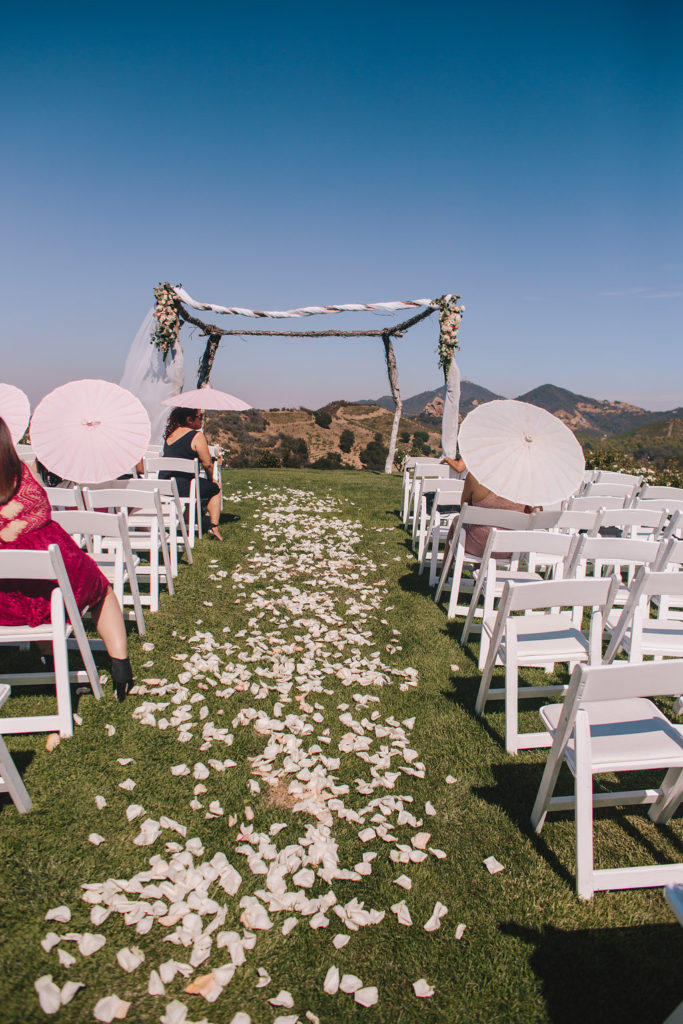 Saddlerock Ranch wedding, ceremony site with flower petals down the aisle