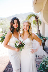 bride and bridesmaid in white dress
