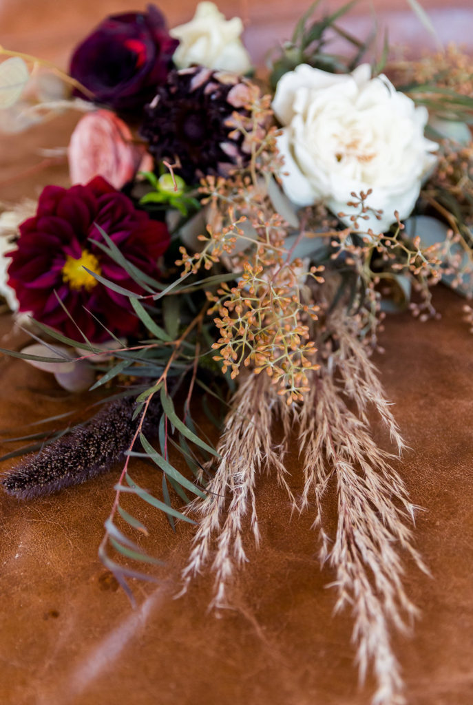 Boho wedding flowers and bouquet with protea and burgundy florals