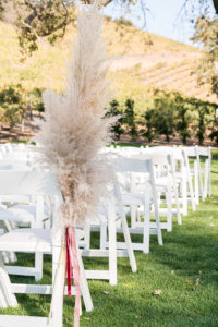 Pampas grass aisle runner with ribbon for a wedding ceremony