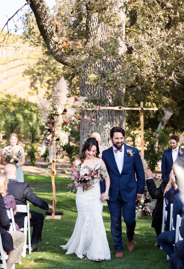 Wedding ceremony at Triunfo Creek Vineyards with wooden arch
