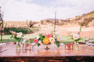 Wildflower pinks and yellow florals for wedding table centerpieces