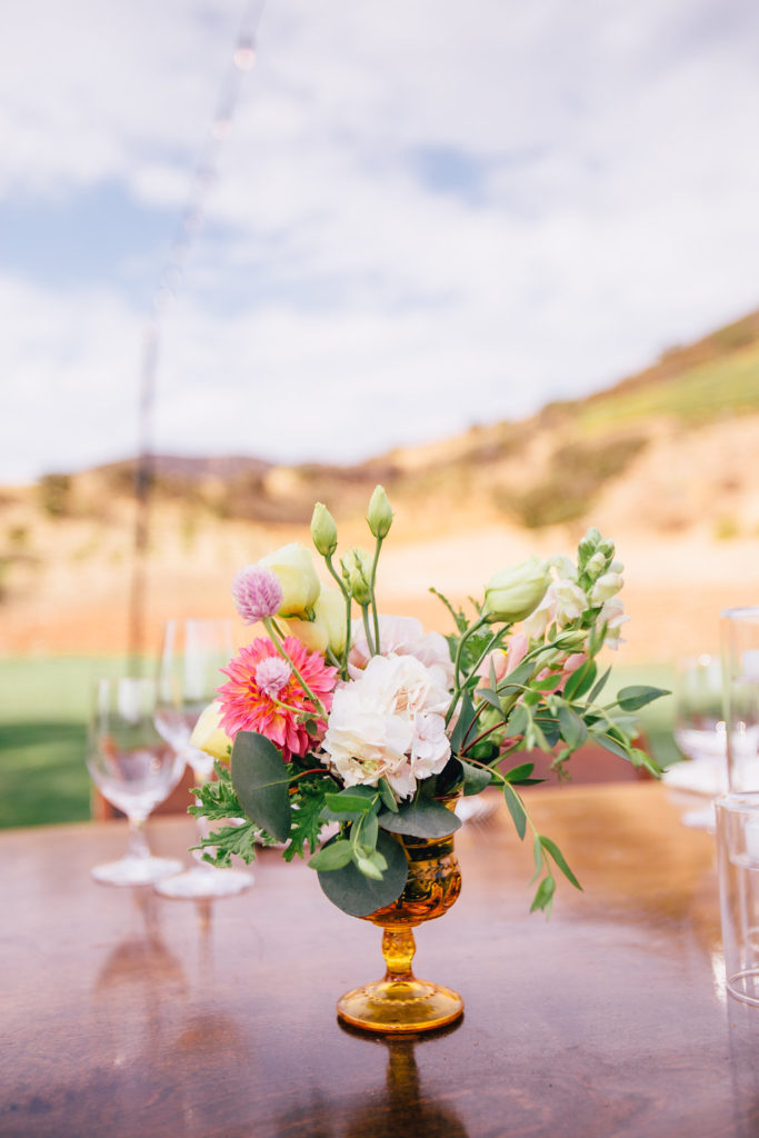 Wildflower pinks and yellow florals for wedding table centerpieces