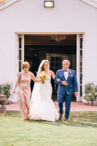 Bride and parents walking down the aisle at Triunfo Creek Vineyards