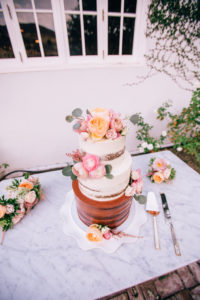 Semi naked white and chocolate cake with bright flowers