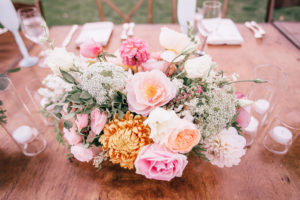 Wildflower wedding centerpieces with yellow, pink, coral flowers