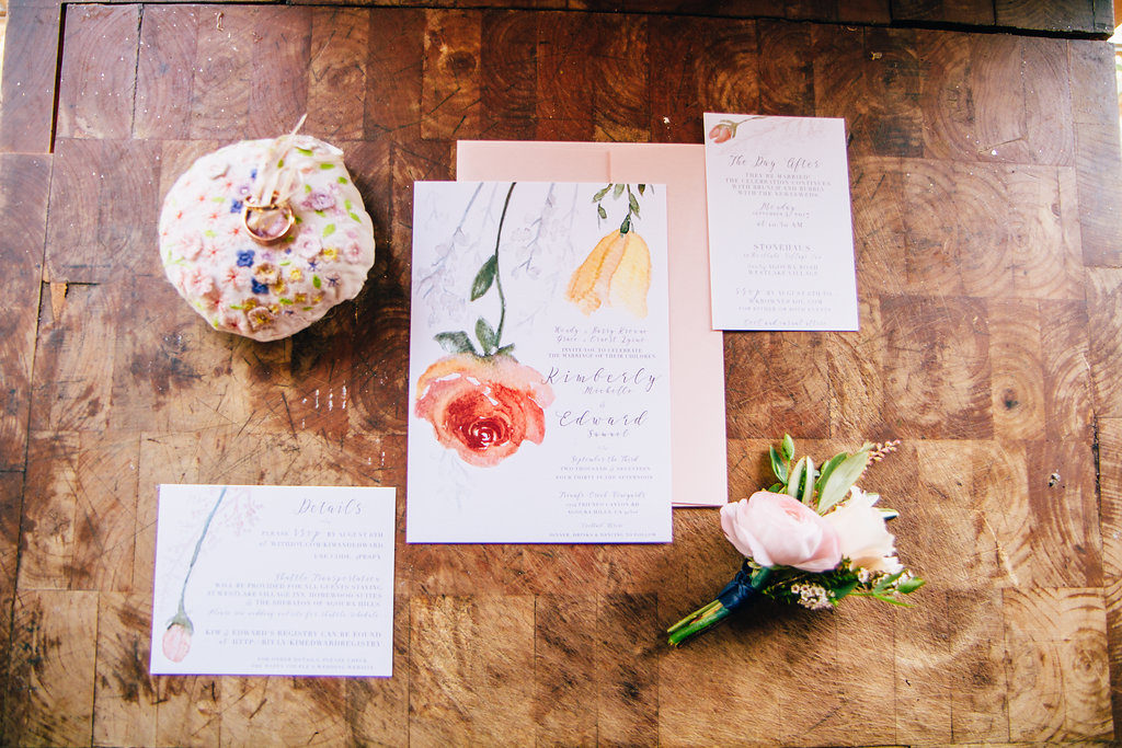 Hand painted and bright colored yellow and red floral wedding invites and stationery at Triunfo Creek Vineyards