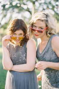 Grey and blue bridesmaids dresses and white floral bouquets at Triunfo Creek Vineyards with fun sunglasses
