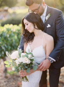 Bride and Groom photos at Triunfo Creek Vineyards Wedding with a white floral bouquet