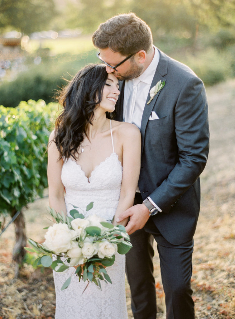 Bride and Groom photos at Triunfo Creek Vineyards Wedding with a white floral bouquet