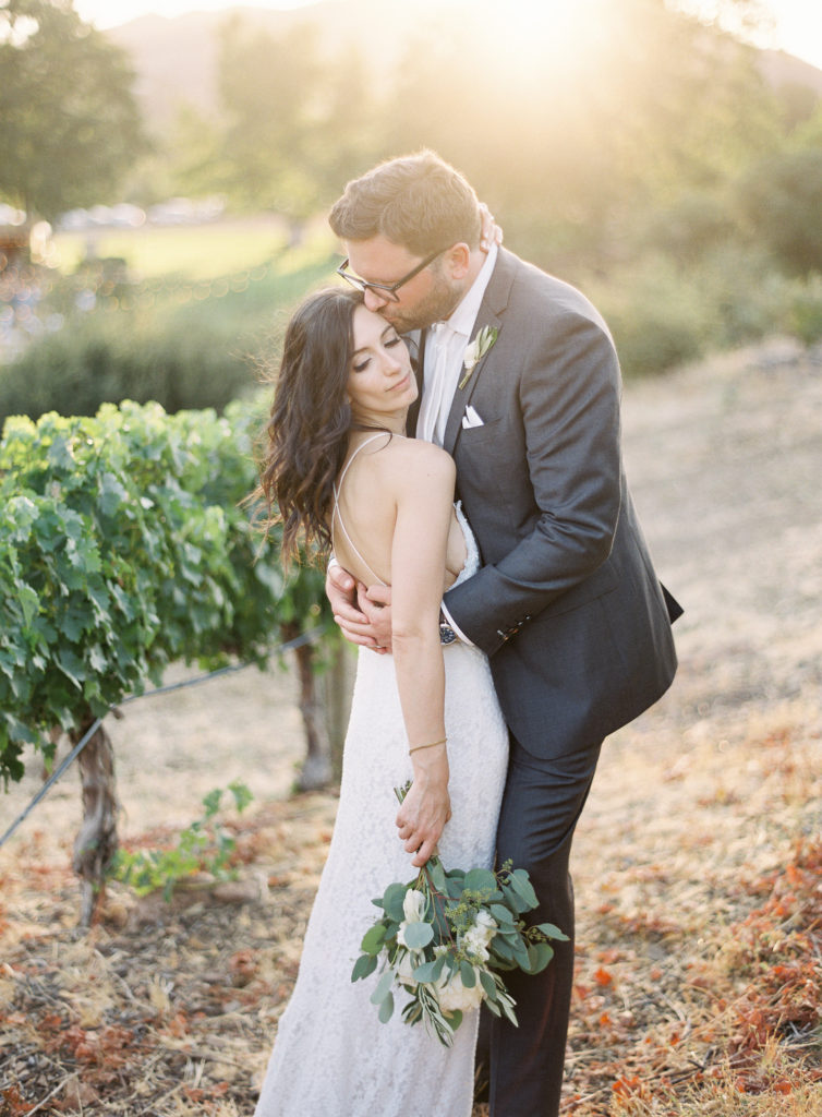 Bride and Groom photos at Triunfo Creek Vineyards Wedding with a white floral bridal bouquet