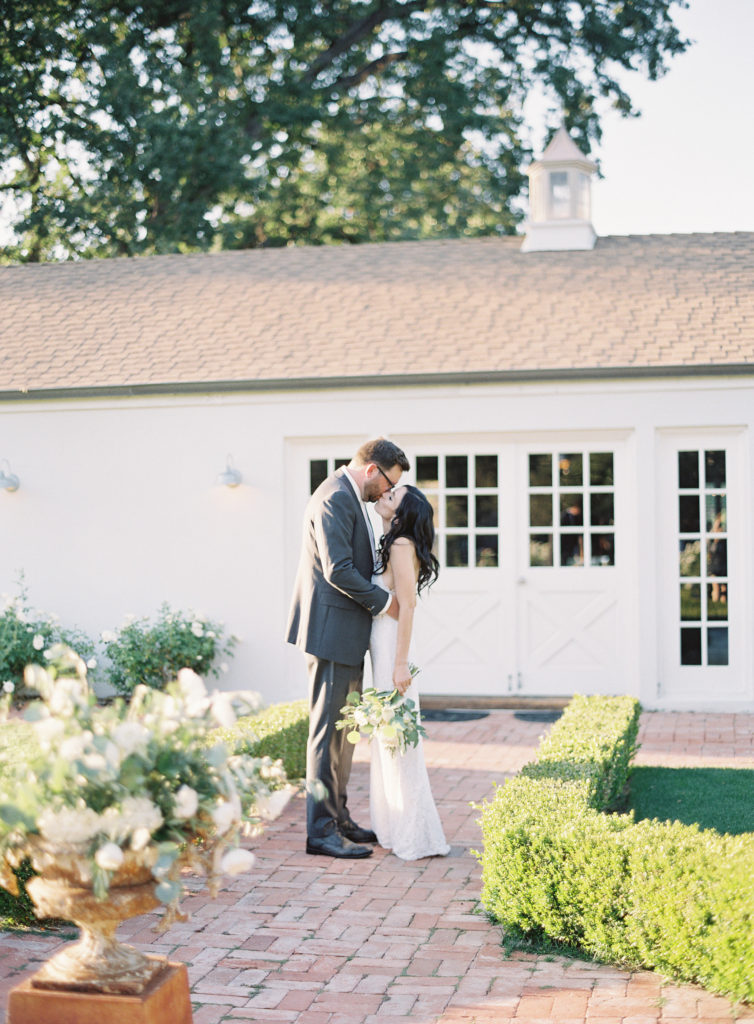 Bride and Groom photos at Triunfo Creek Vineyards in front of the farmhouse
