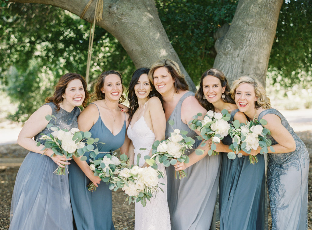 Grey and blue bridesmaids dresses and white floral bouquets at Triunfo Creek Vineyards