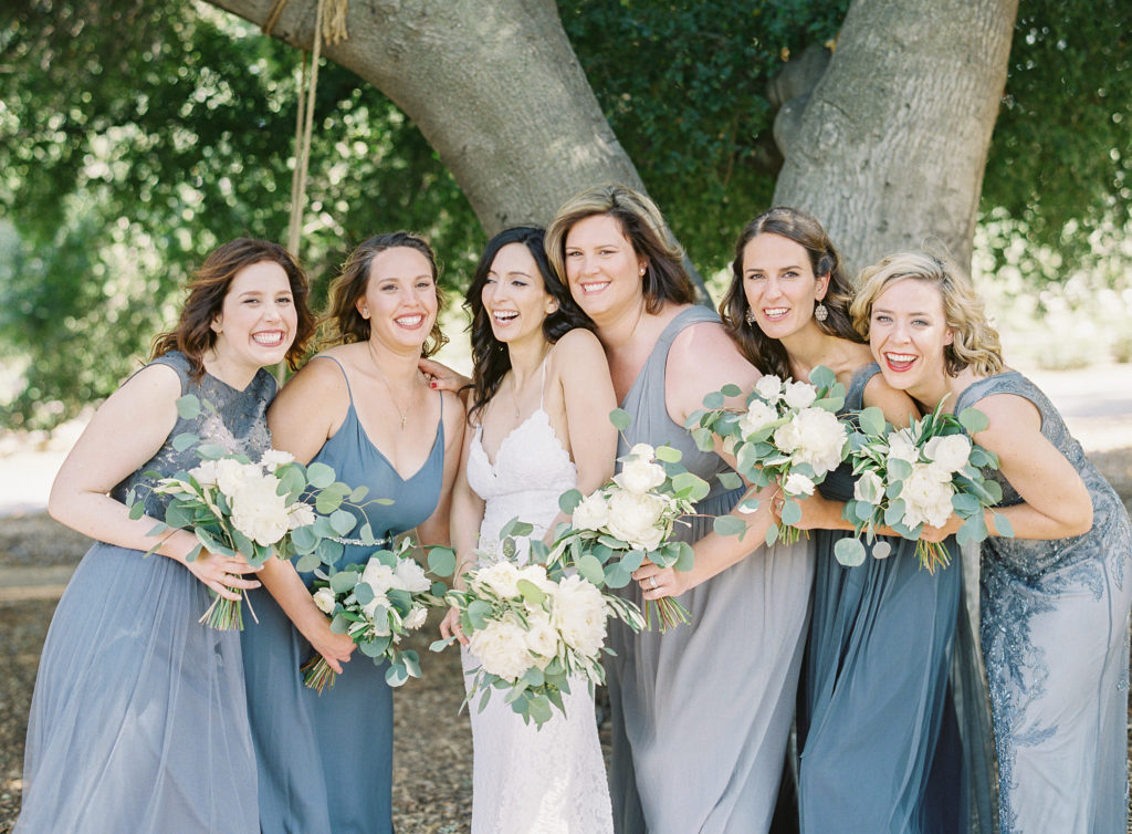 Grey and blue bridesmaids dresses and white floral bouquets at Triunfo Creek Vineyards