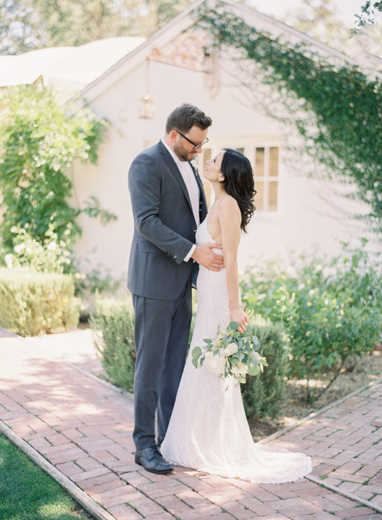 Bride and Groom photos at Triunfo Creek Vineyards in front of the farmhouse