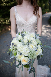 blue, green and white bridal bouquet, white beaded wedding dress