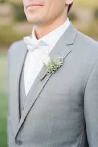 white bowtie, grey groomsmen suit, white spray rose boutonniere