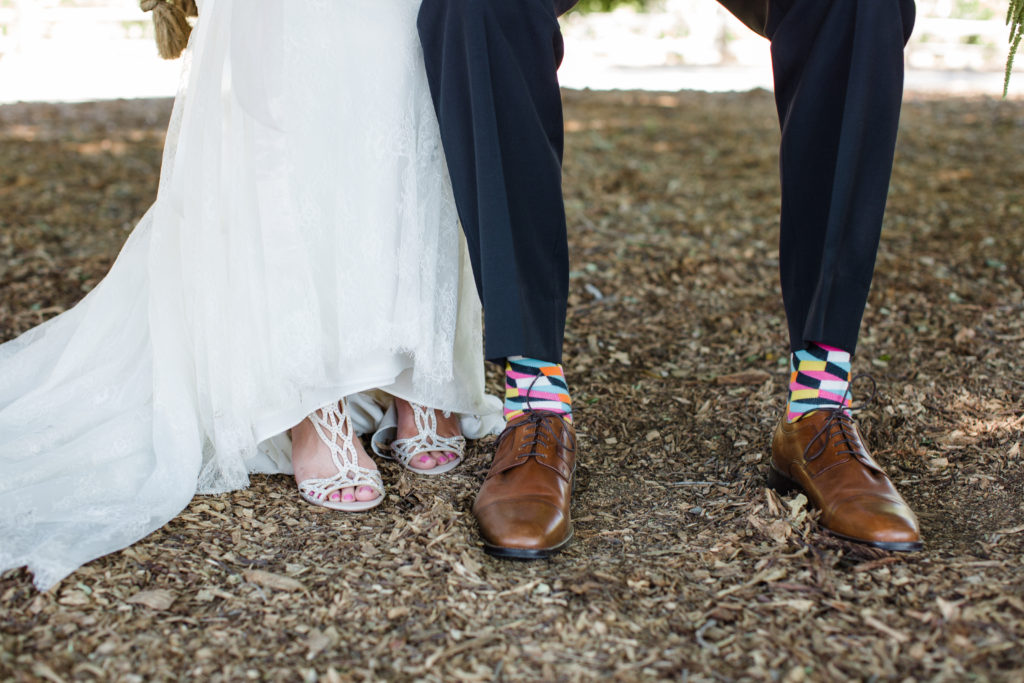 Triunfo Creek Vineyards wedding, groom wearing multicolored socks, adding a pop of color to your big day